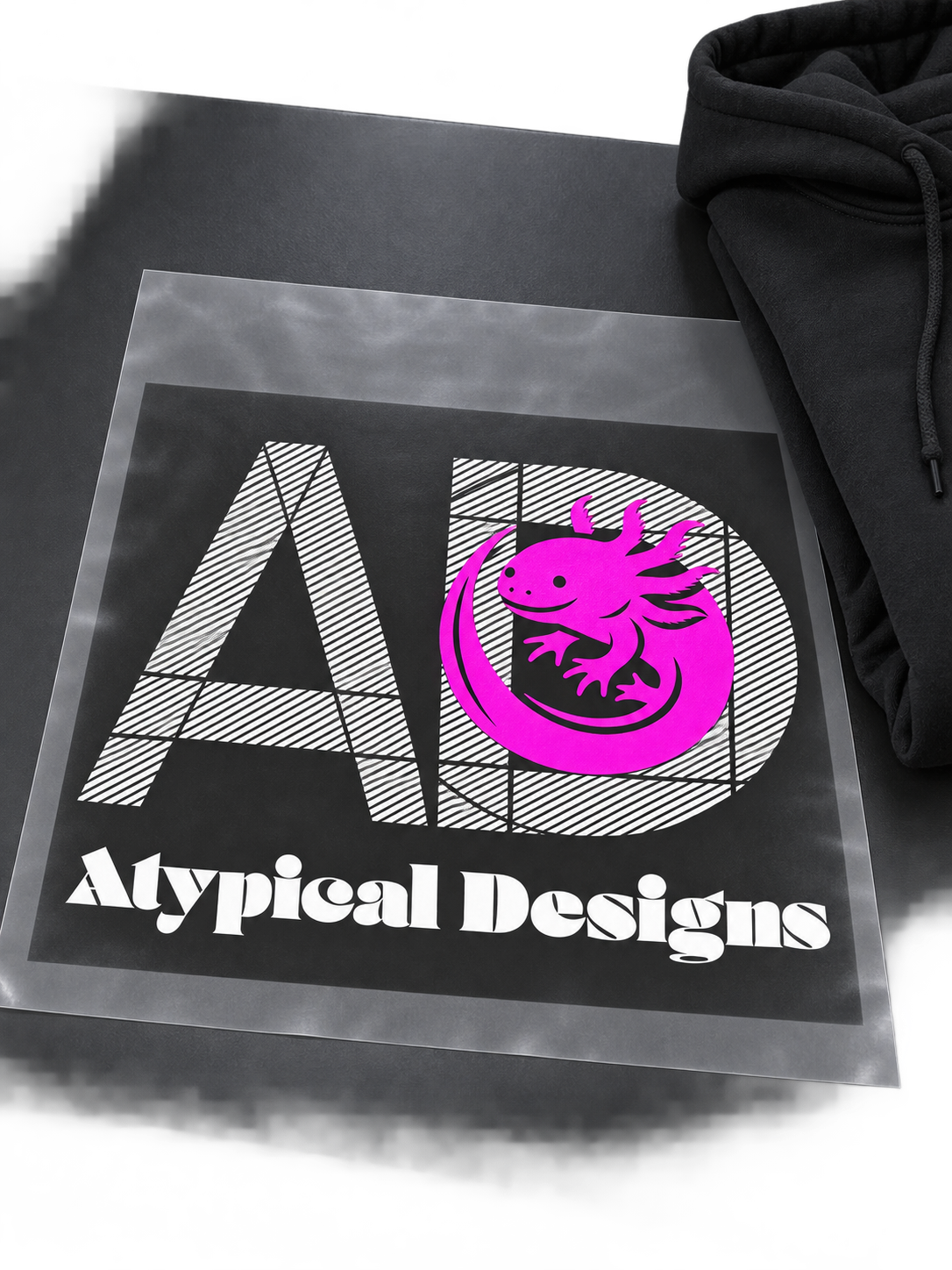 Custom DTF Graphic Transfer 12 × 16 in mockup featuring Atypical Designs logo on carrier film