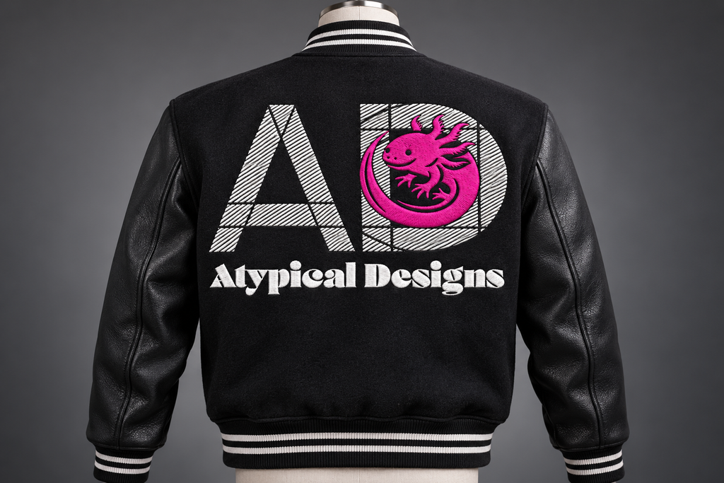 Custom Embroidered Item 10 × 6 in embroidery area mockup with Atypical Designs logo on jacket back