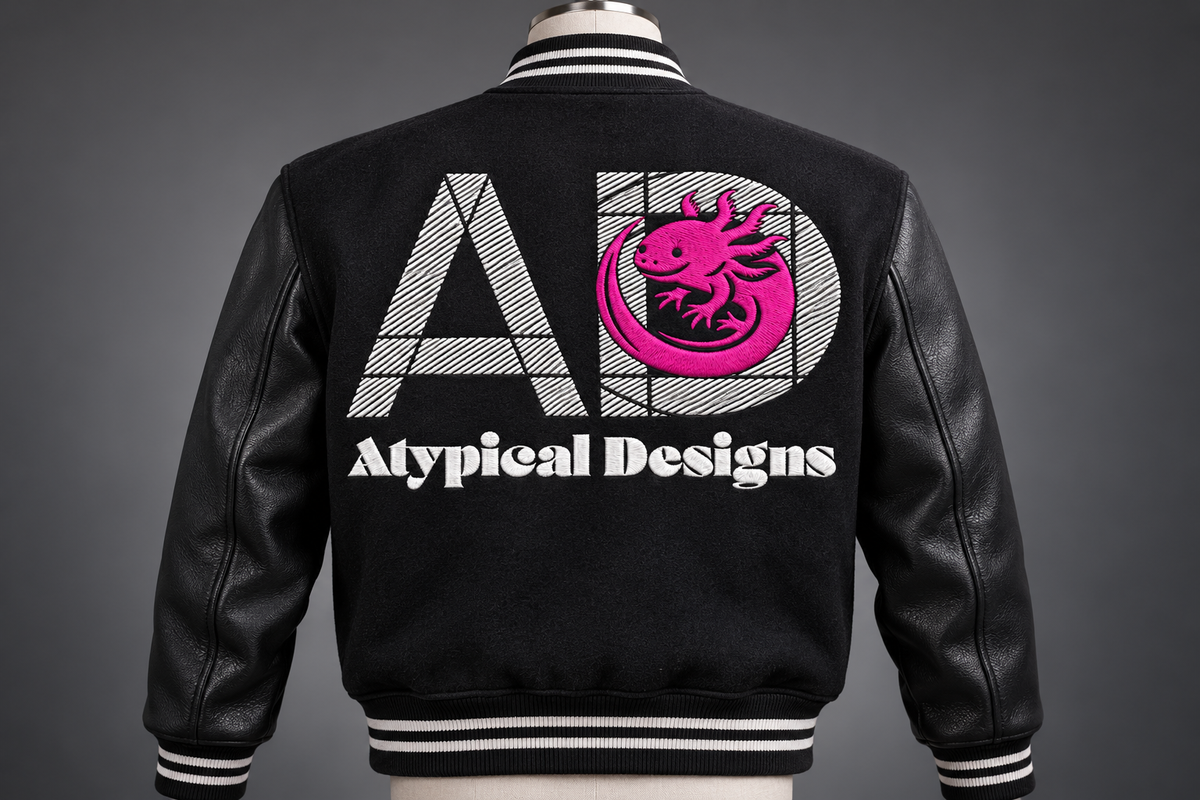 Custom Embroidered Item 10 × 6 in embroidery area mockup with Atypical Designs logo on jacket back