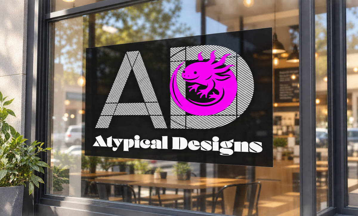 Custom Window Graphic 24 × 12 in mockup featuring Atypical Designs logo on glass